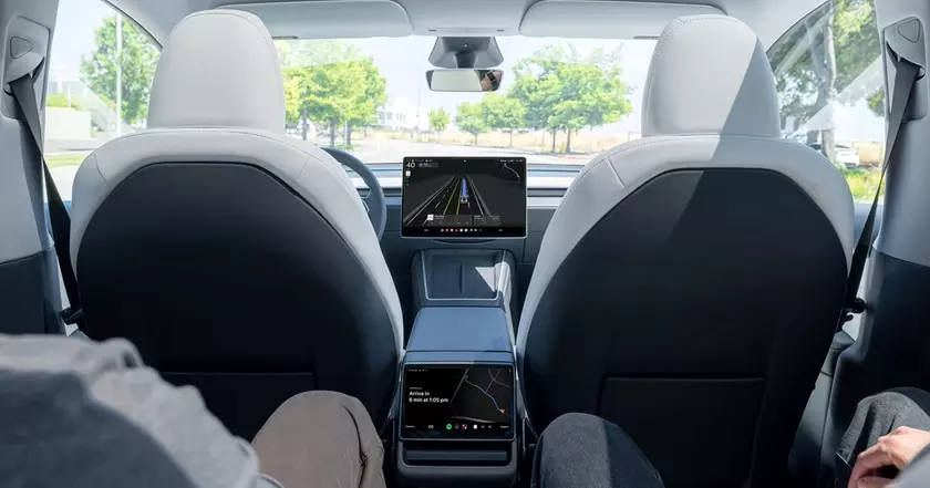 Электромобиль Tesla на дороге с включенной системой автопилота