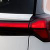 Миниатюра Chevrolet Bolt EV на фоне завода