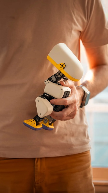 The robot's beak can grasp small objects, while onboard LiDAR and a camera handle navigation.
