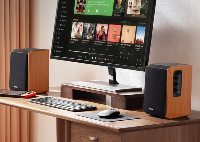 Edifier R1000TC II desktop speakers feature MDF cabinets, removable front grilles, and physical volume/tone controls on the active unit.